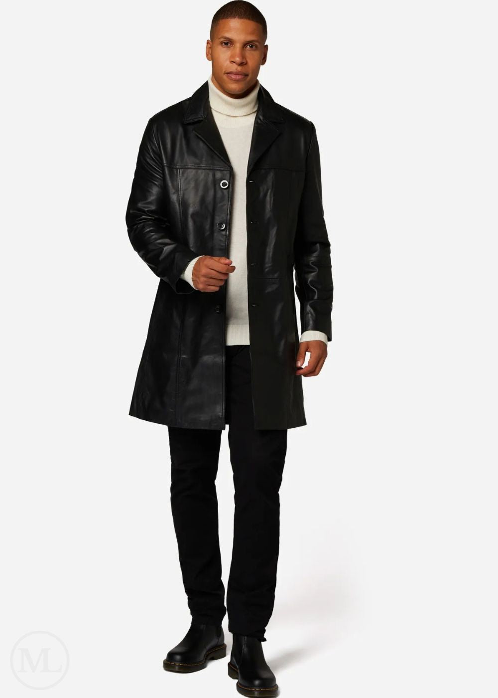 Man wearing a black leather trench coat over a white turtleneck on a white background