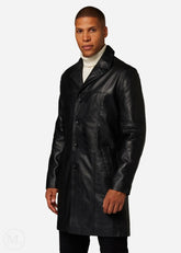 Man wearing a black leather trench coat on a white background