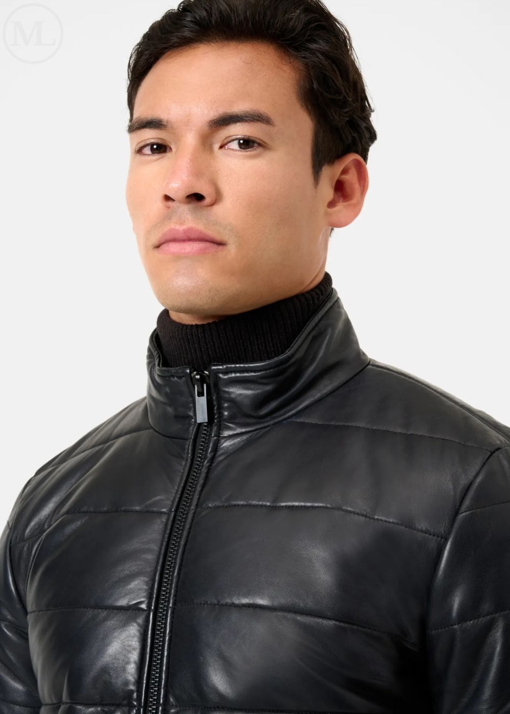 Man wearing a black leather puffer jacket against a white background
