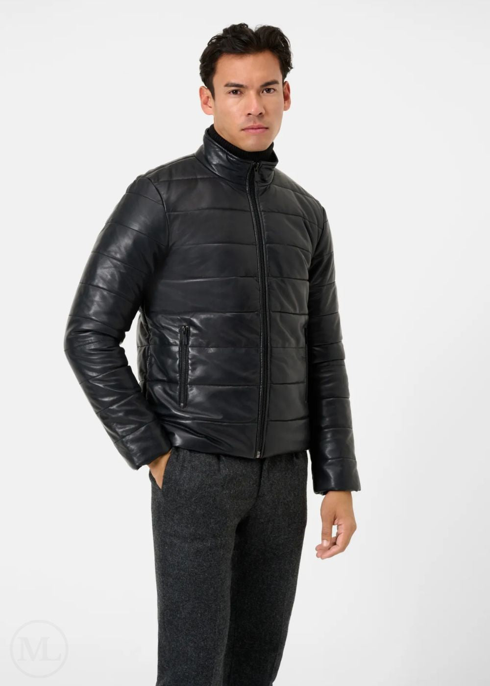 Man wearing a black leather puffer jacket on a white background