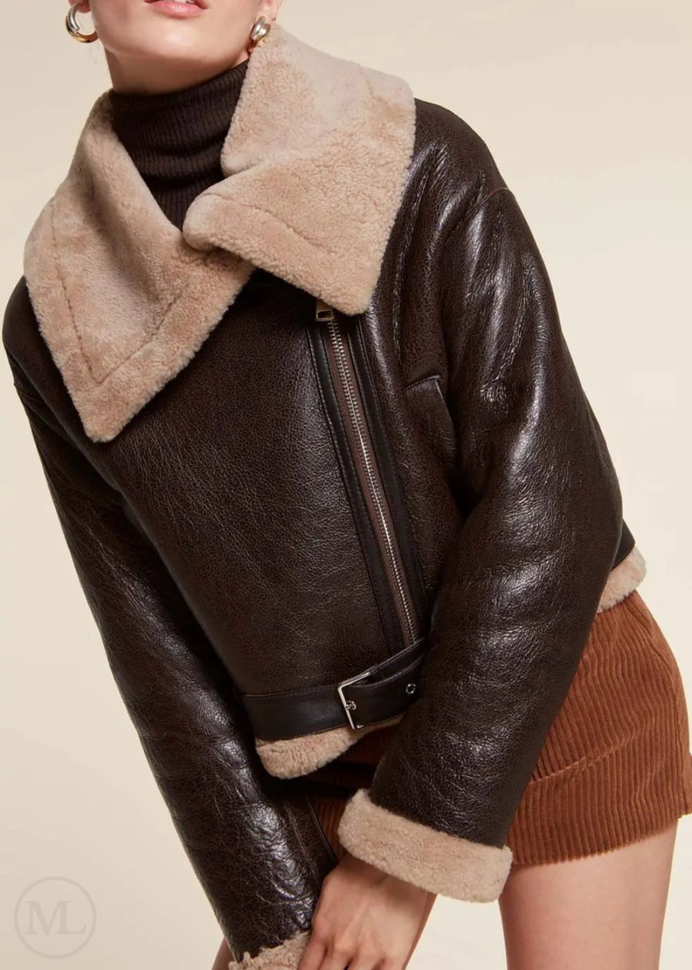 Woman wearing a dark Brown aviator jacket with beige fur collar and trim on a neutral background