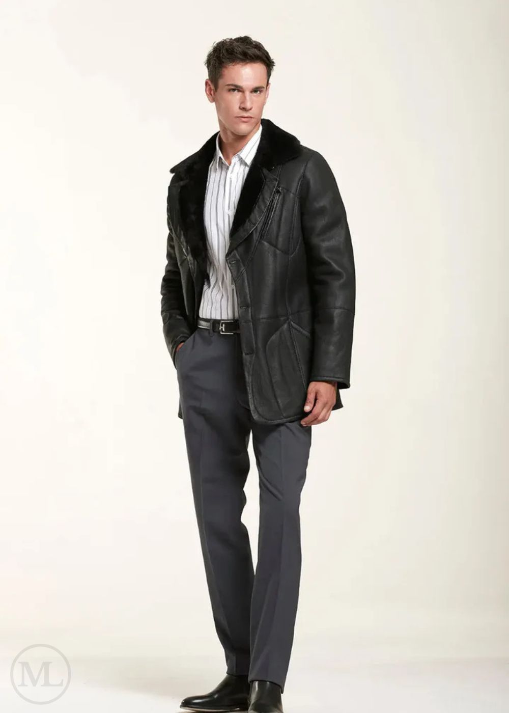 Man wearing a black leather shearling jacket over a suit on a white background