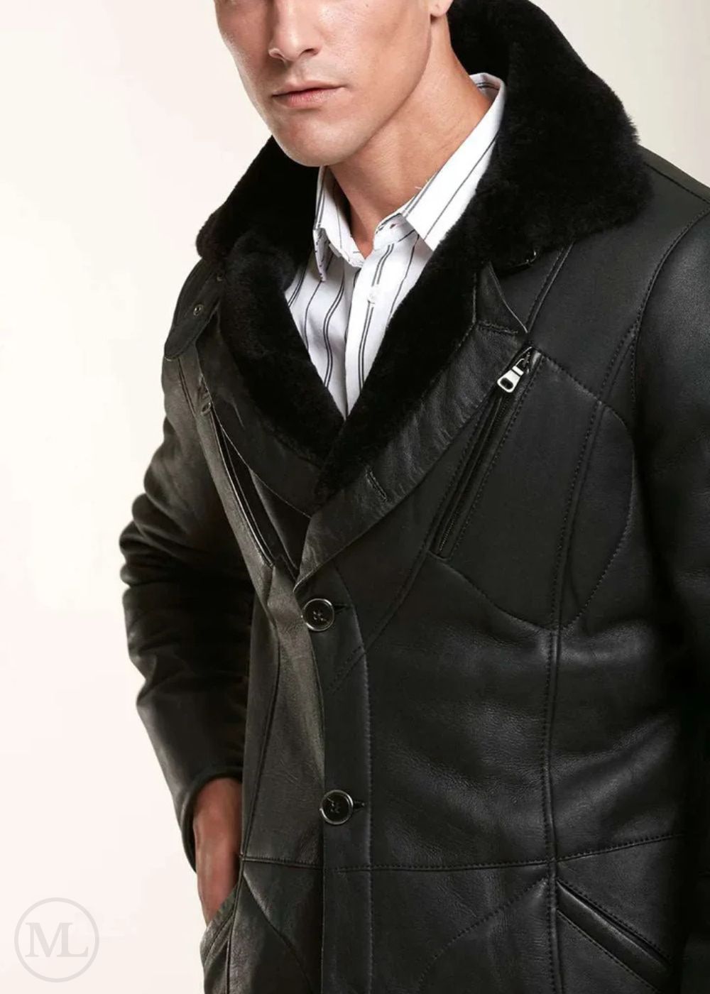 Man wearing a black leather shearling jacket with fur collar on a light background