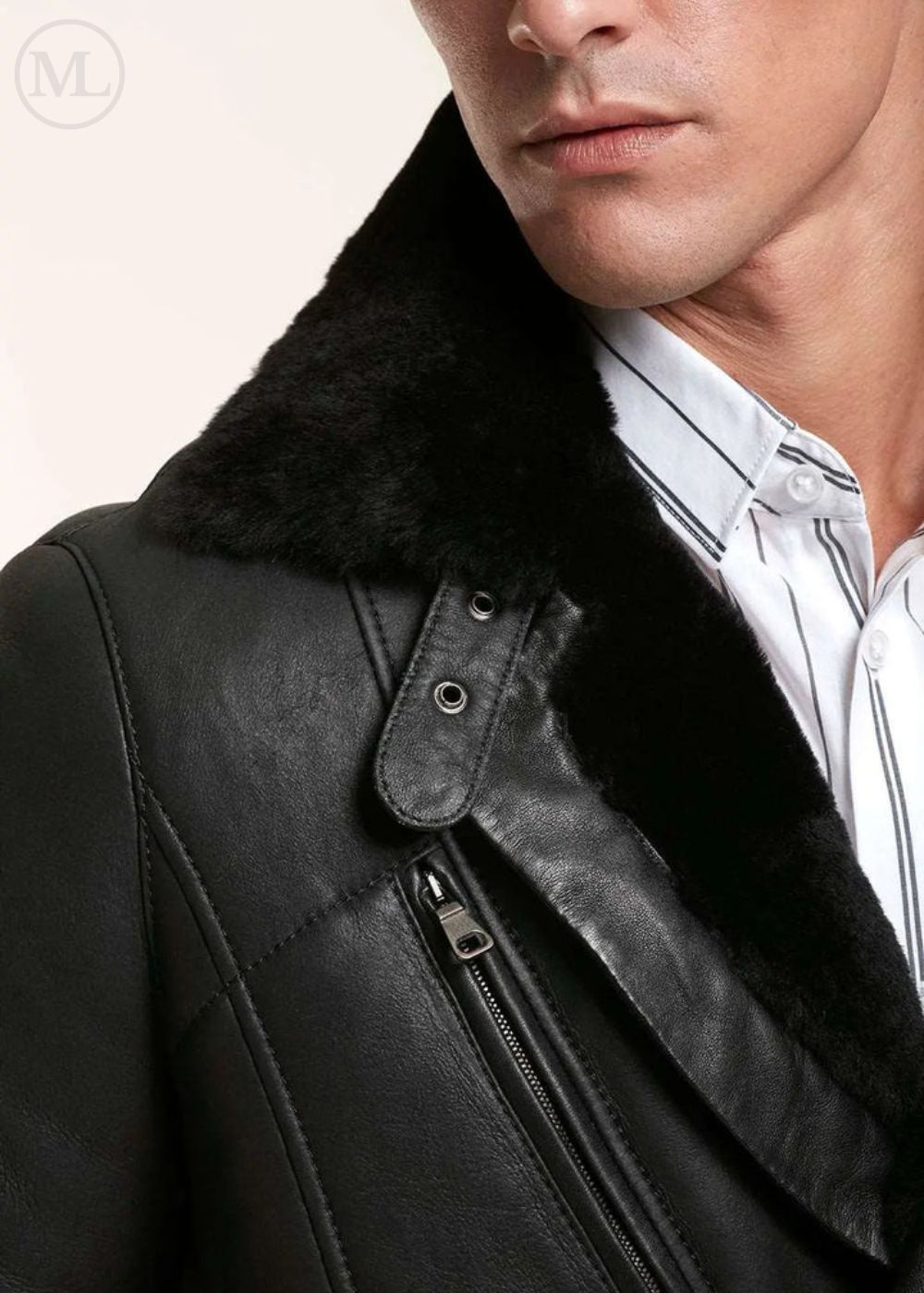 Close-up of a black leather shearling jacket with fur collar worn by a man.