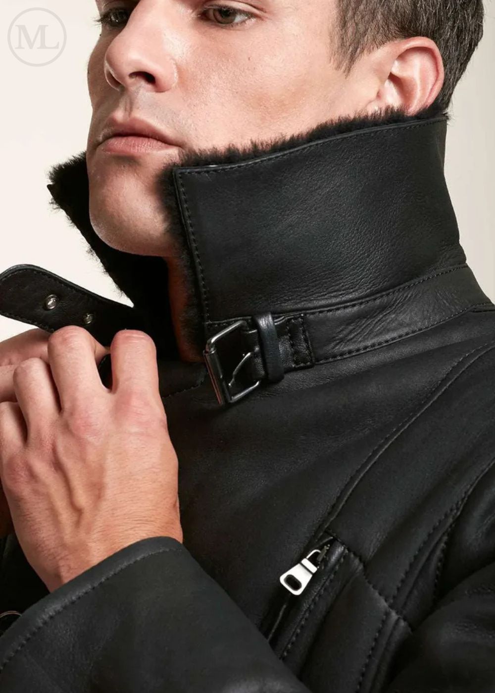 Close-up of a man wearing a black leather shearling jacket with a high collar.