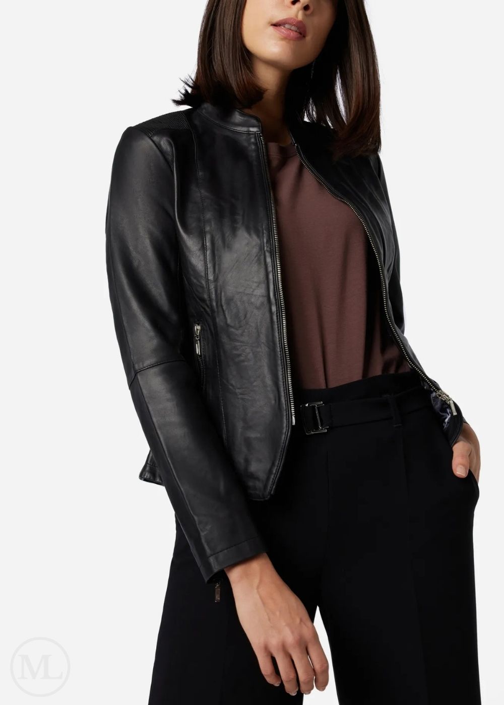 Woman wearing a black leather jacket over a brown top on a white background