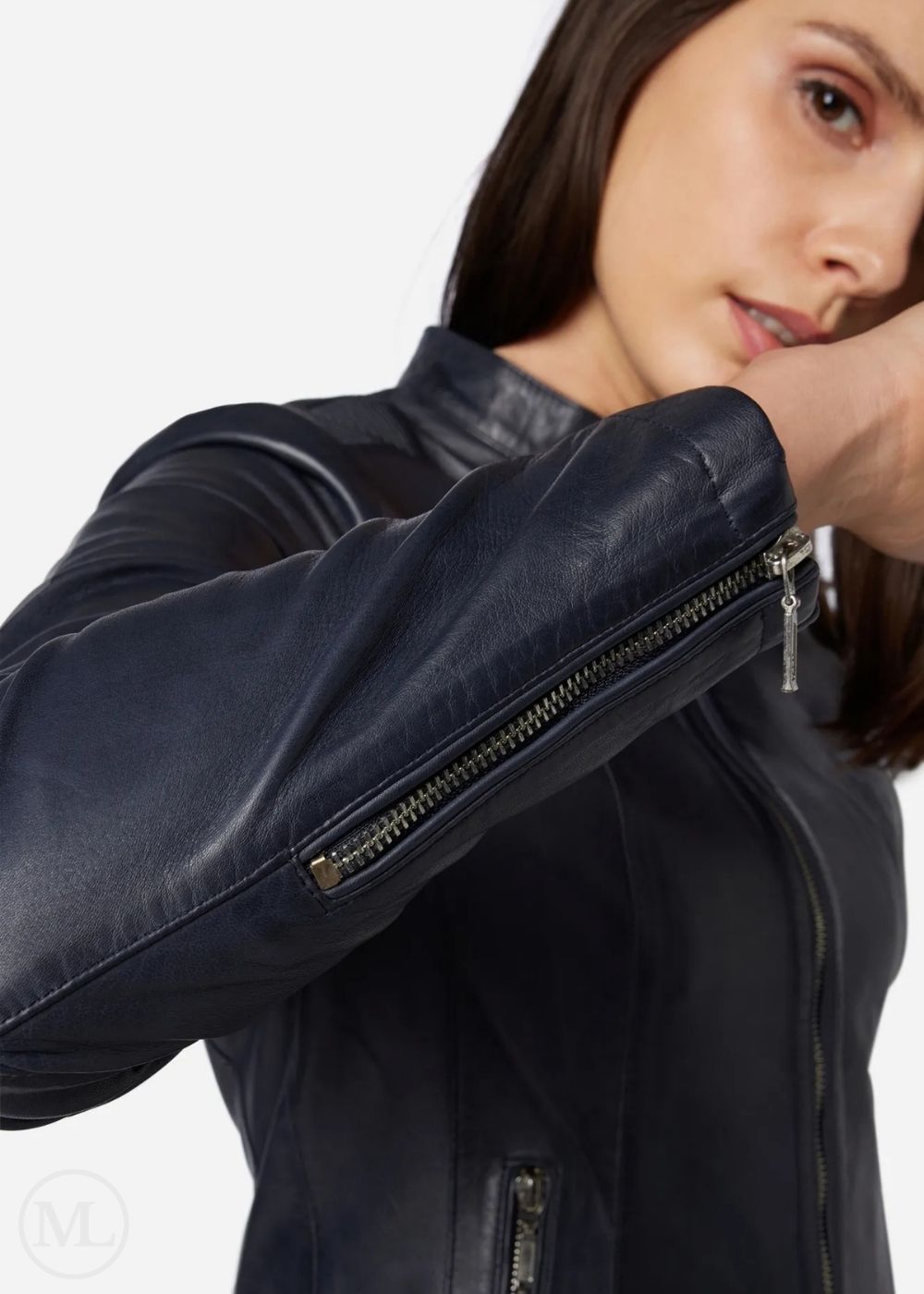 Woman wearing a blue jacket with zippers on a white background