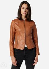 Woman wearing a cognac brown leather jacket on a white background