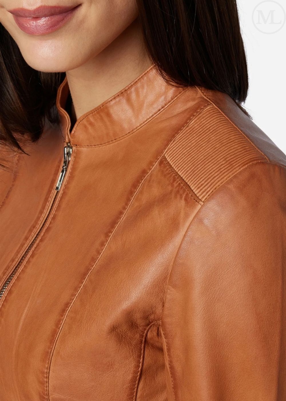 Close-up of a cognac brown leather jacket worn by a person
