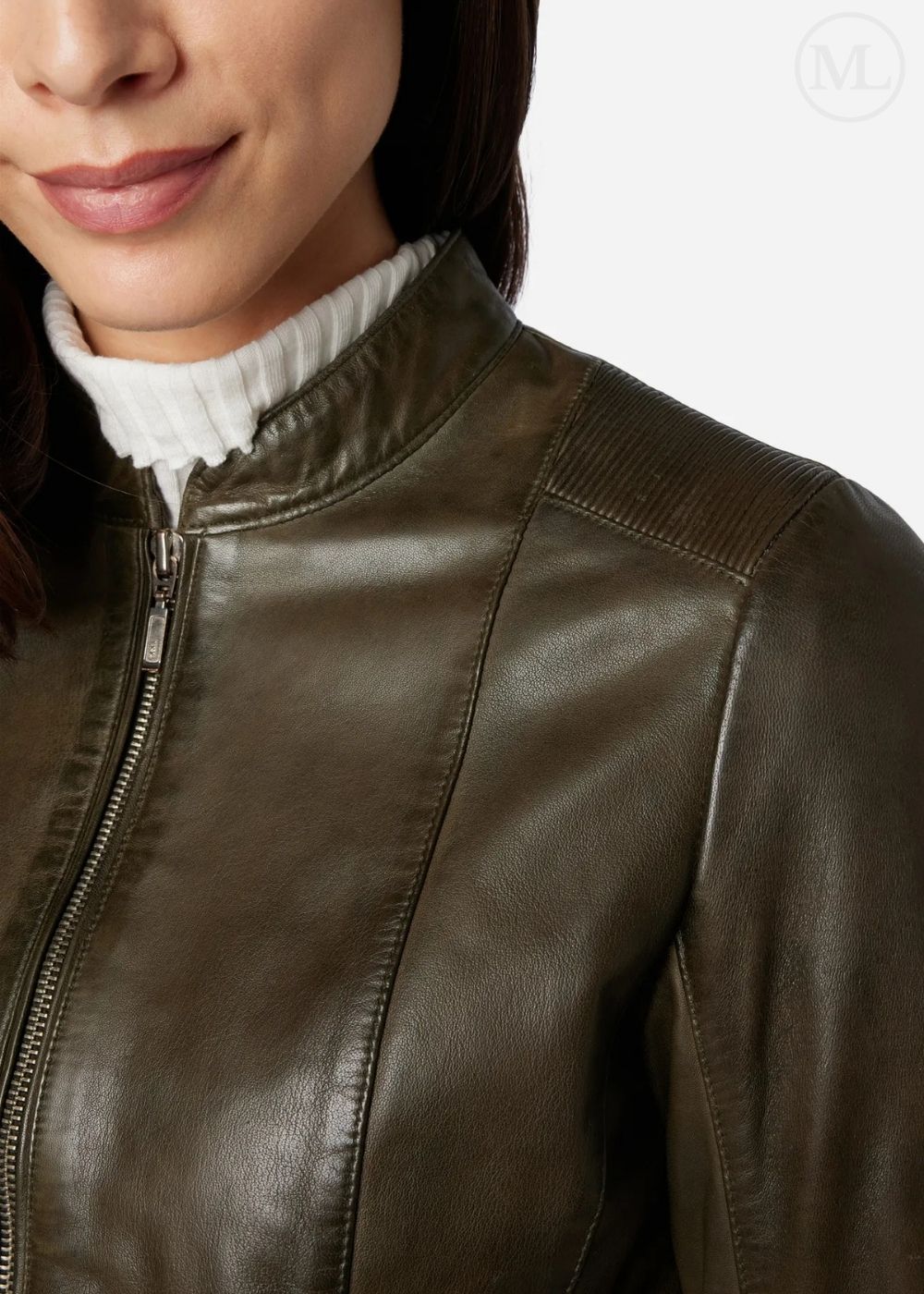 Close-up of a olive green leather jacket worn by a person with a white turtleneck visible.