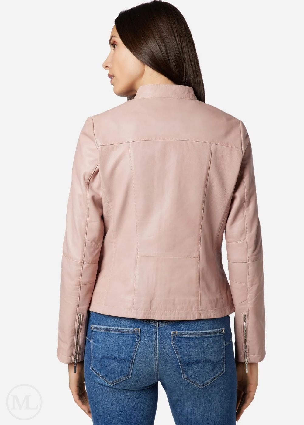 Woman wearing a rose gold leather jacket and blue jeans on a white background