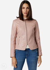 Woman wearing a rose gold leather jacket and blue jeans on a white background