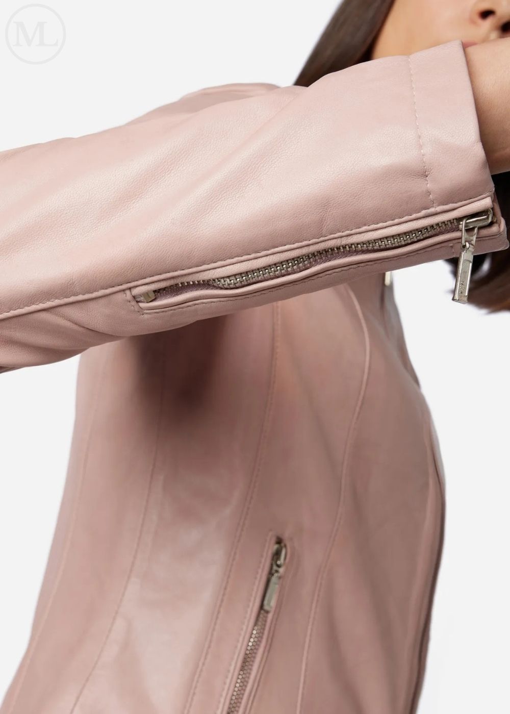 Close-up of a rose gold leather jacket with zippers on a white background