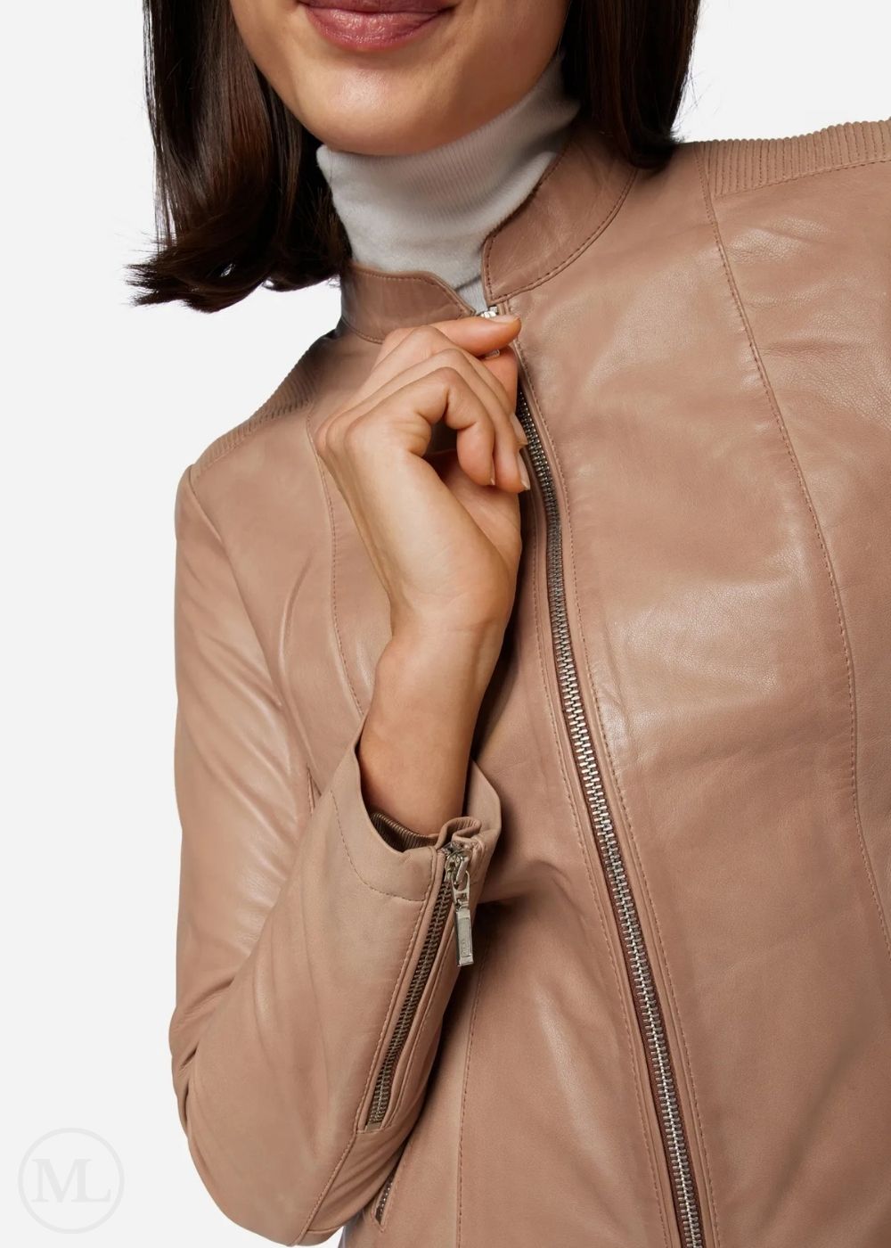 Close-up of a woman wearing a taupe leather jacket with a white background