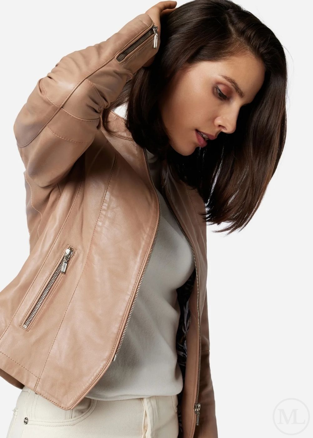 Woman wearing a taupe leather jacket on a white background