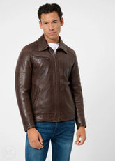 Man wearing a dark brown leather racer jacket on a white background