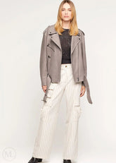 Woman wearing a gray Oversized Nubuck Leather Biker Jacket with Belted Waist and white pinstripe pants on a white background