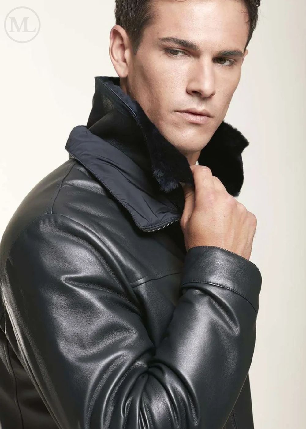 Man wearing a black leather jacket against a plain background