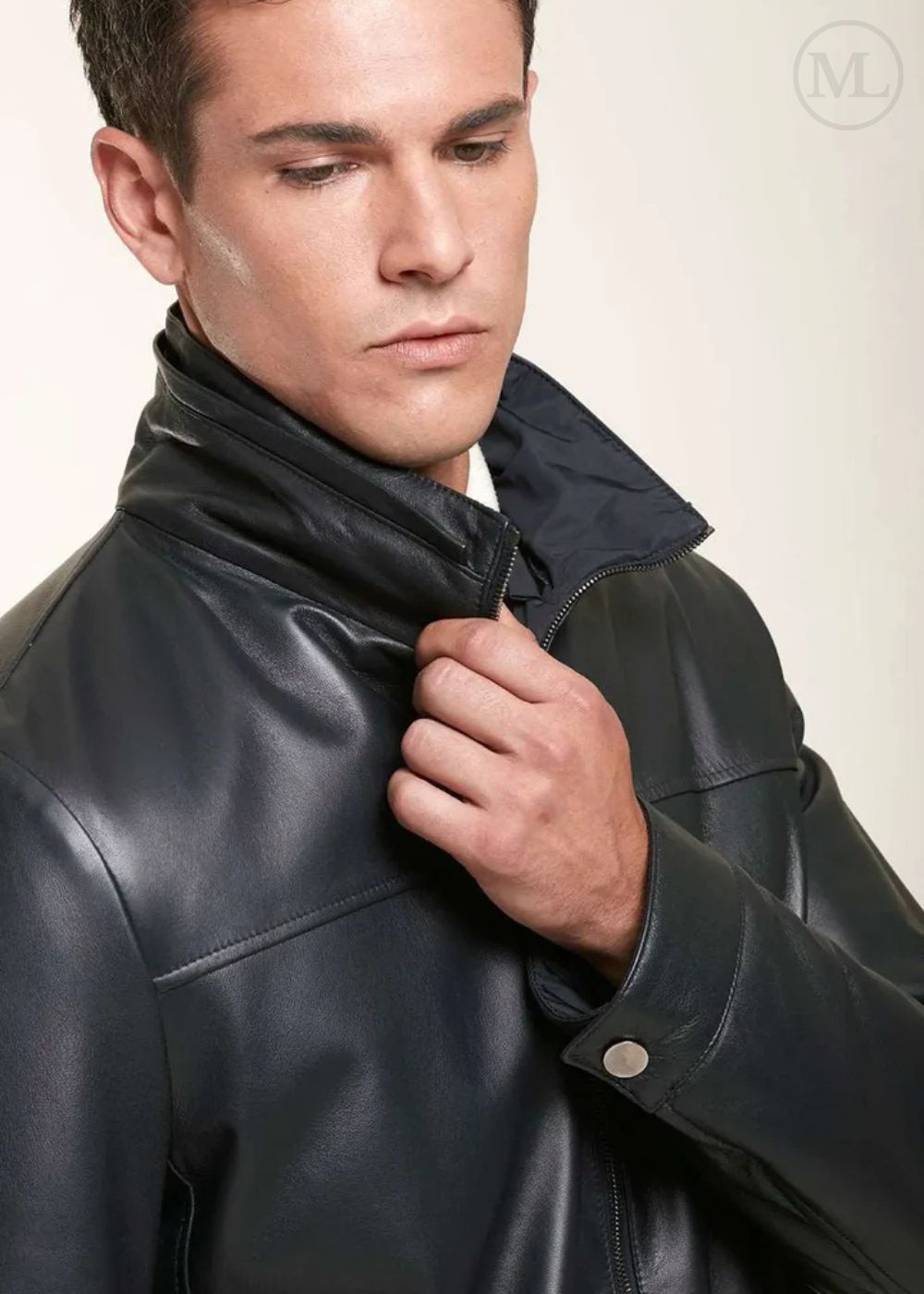 Man wearing a black leather jacket against a plain background