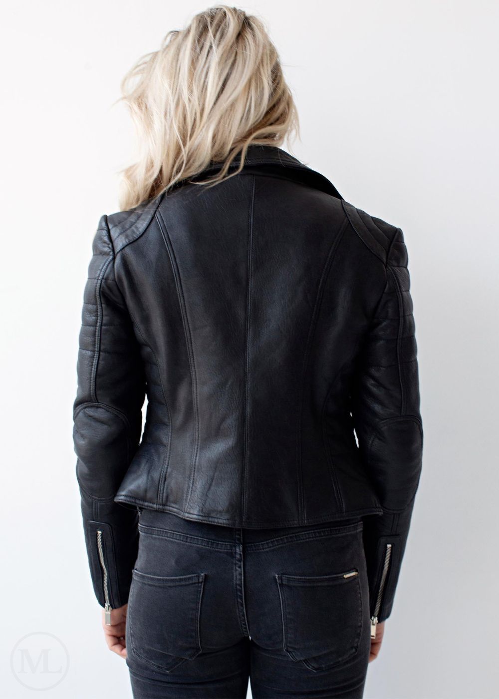 woman wearing a black leather jacket on a white background