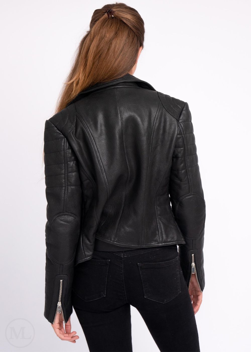woman wearing a black leather jacket and jeans on a white background