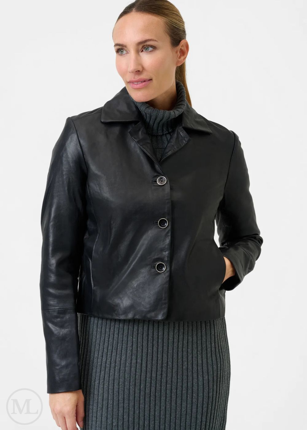 Woman wearing a black leather blazer jacket on a white background