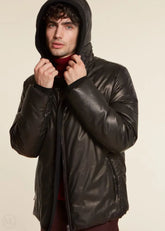 Man wearing a black leather jacket on a beige background