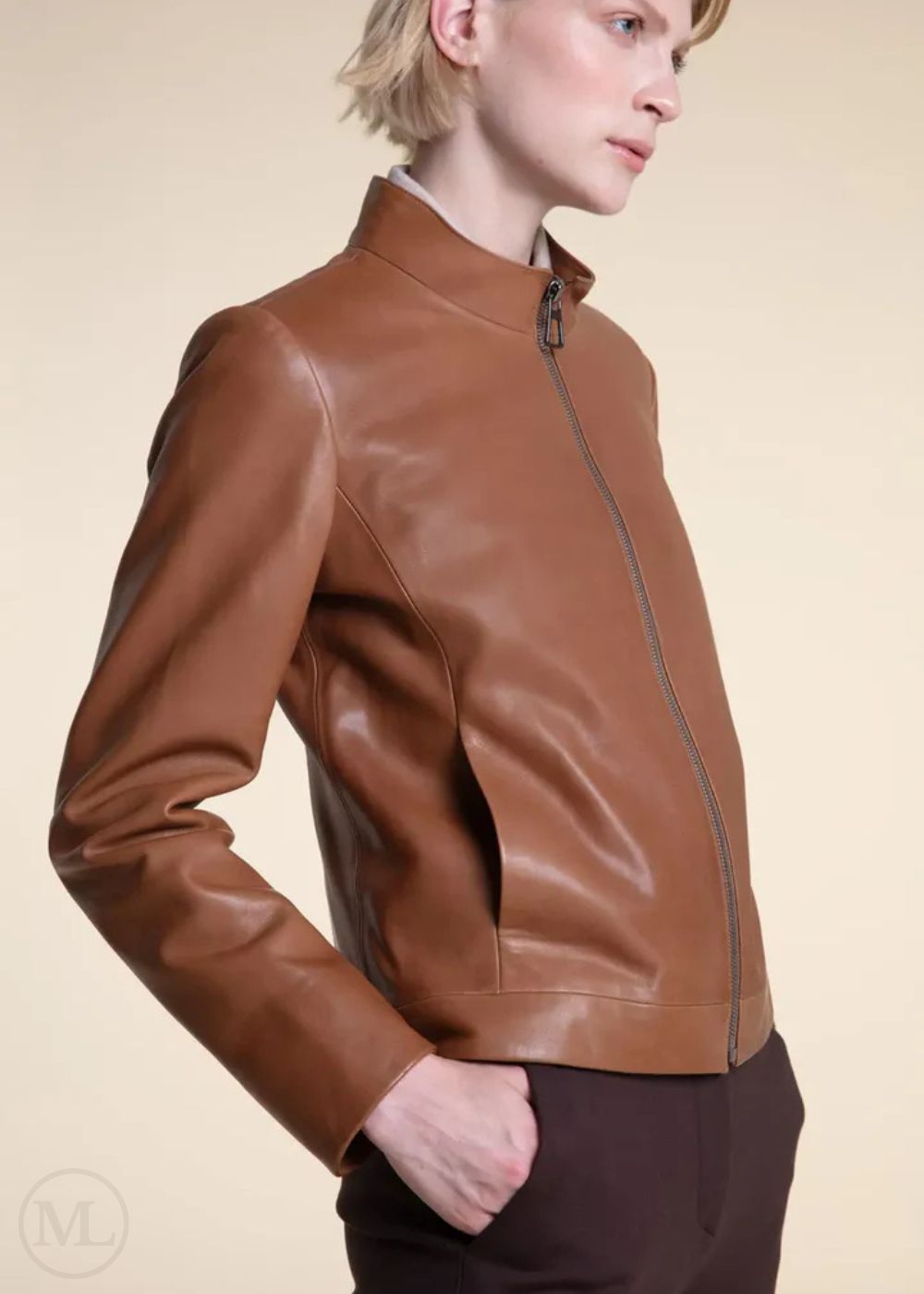 Women Wearing a Brown leather moto jacket worn by a person on a beige background