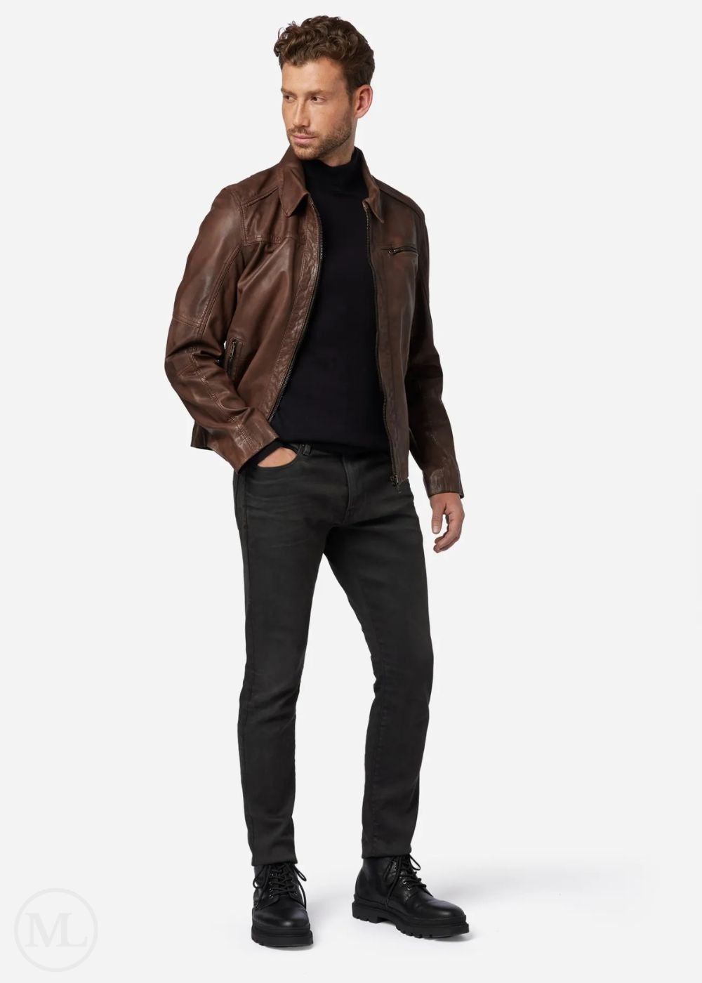 Man wearing a brown leather jacket, black turtleneck, black jeans, and black boots on a white background