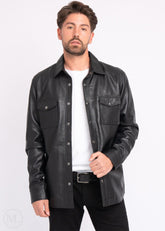 Man wearing a black leather jacket over a white shirt on a white background