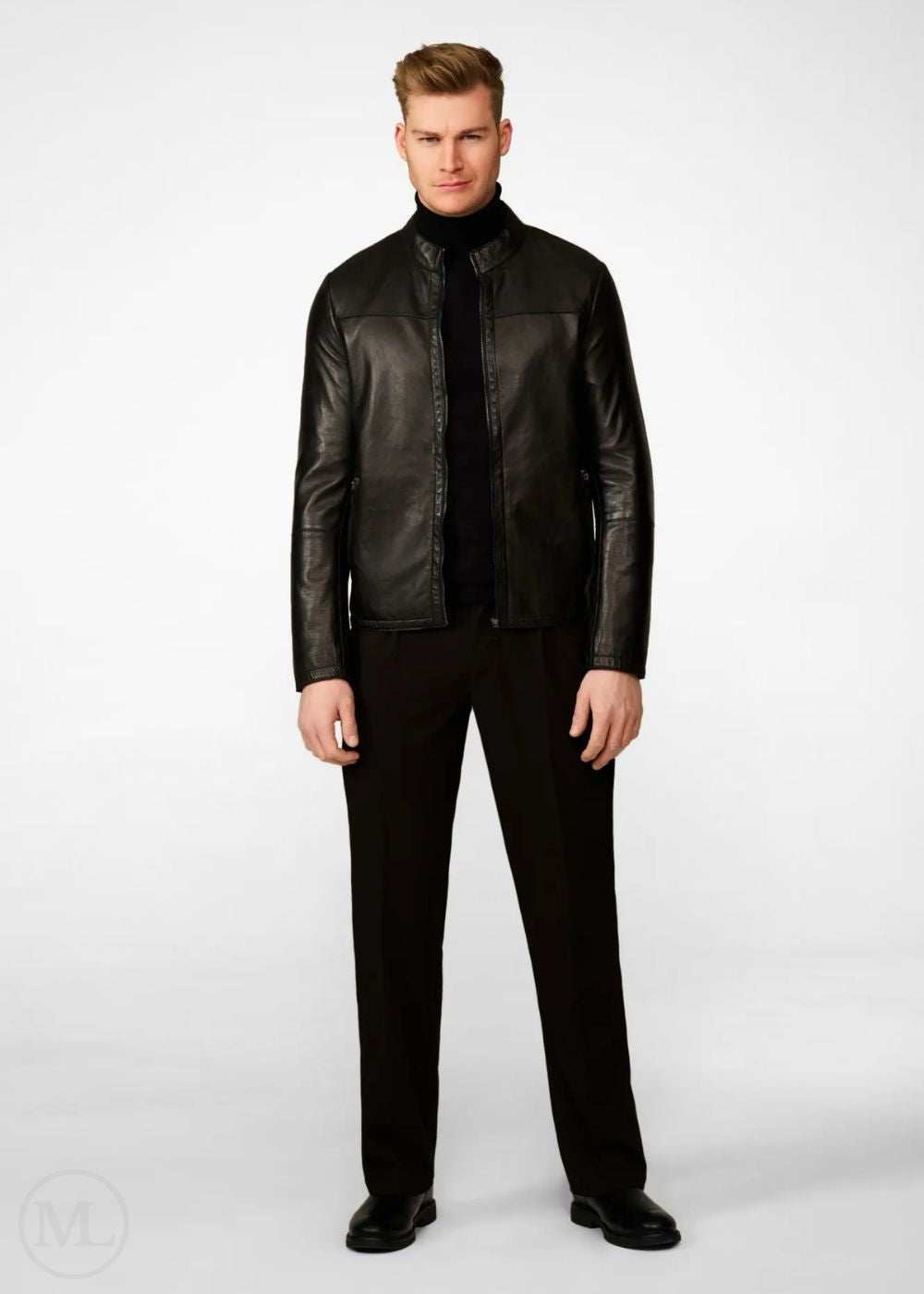 Man wearing a black leather biker jacket and black pants on a white background