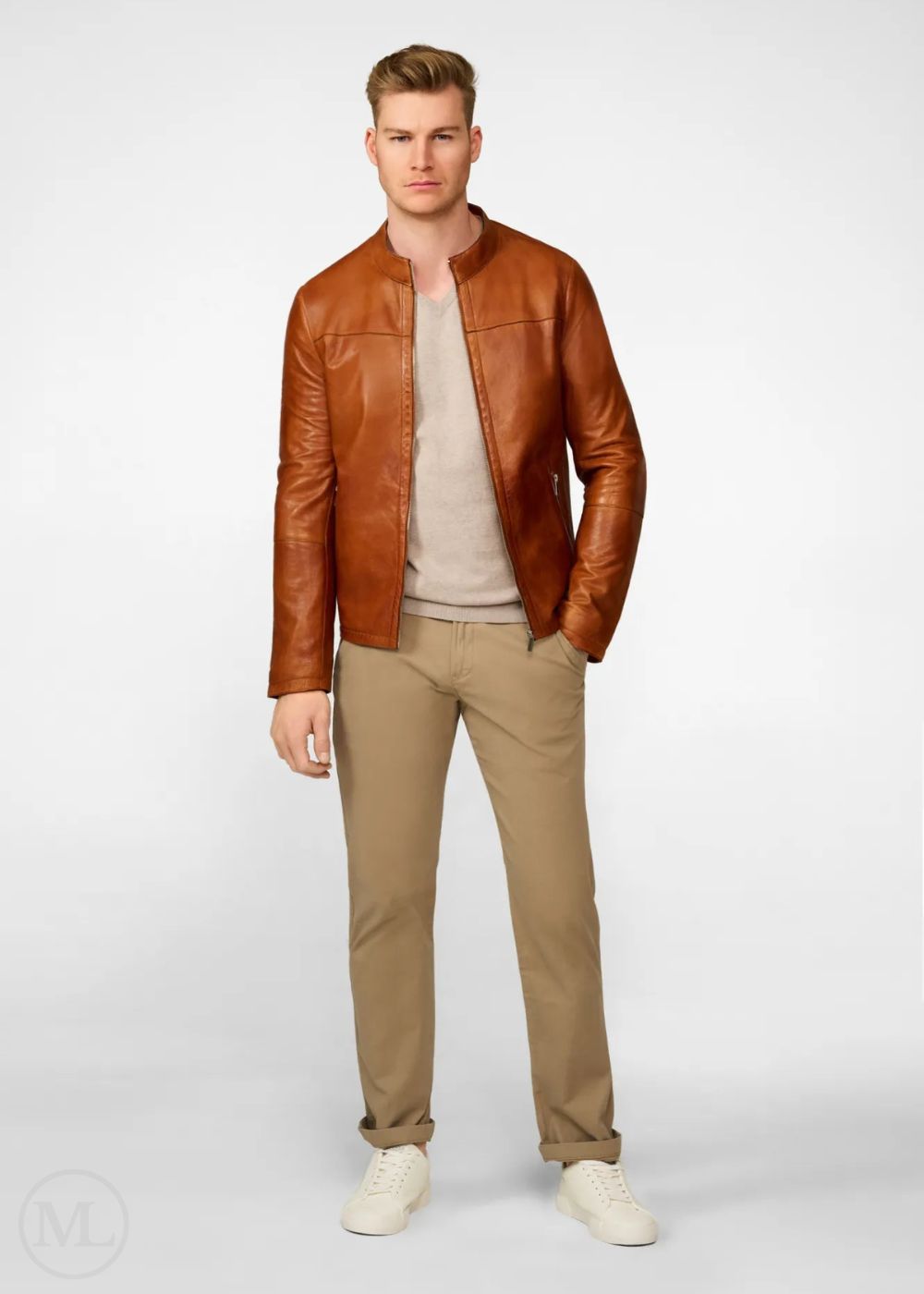 Man wearing a brown leather biker jacket, beige shirt, and pants on a white background