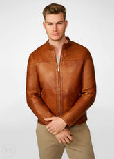 Man wearing a brown leather biker jacket on a white background