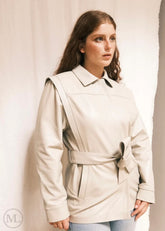 Woman wearing a Lvory Leather coat against a plain background