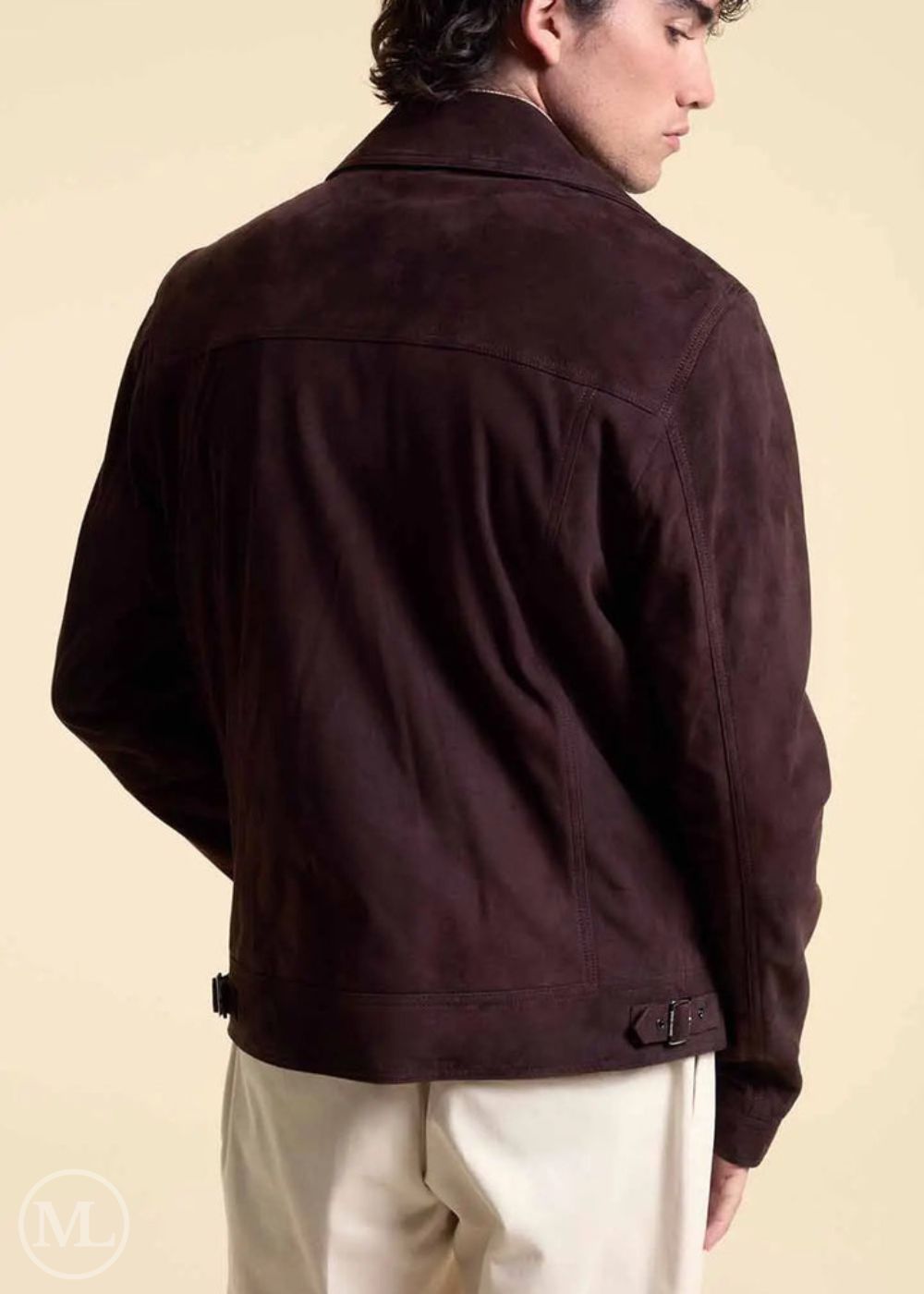 Man wearing a dark brown suede jacket on a beige background