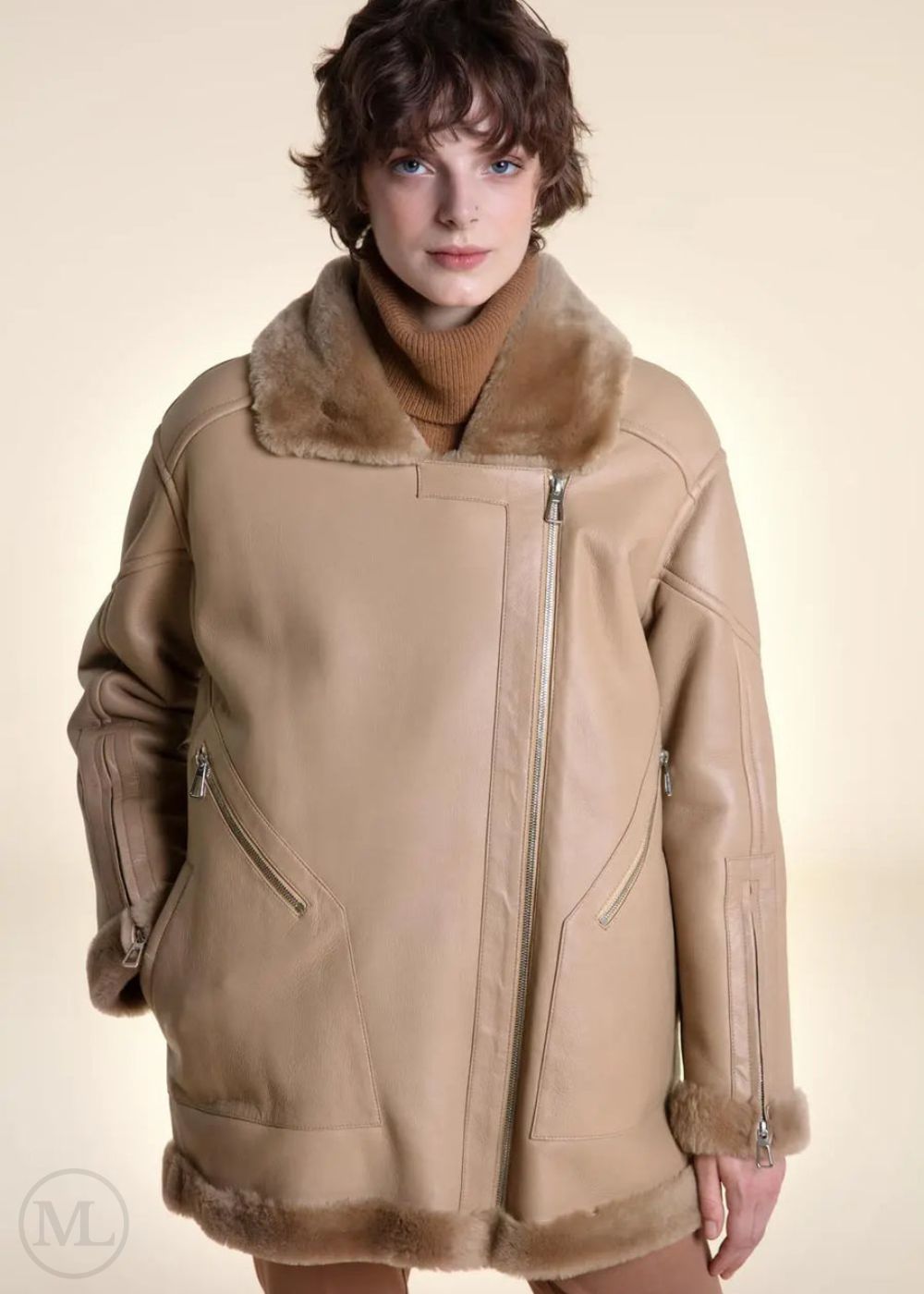 Woman wearing a camel Shearling leather coat with fur collar on a beige background