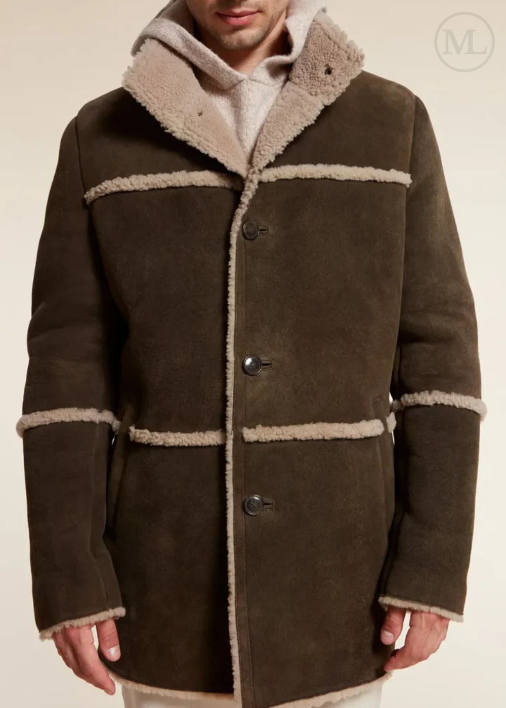 Brown suede shearling coat with beige trim on a neutral background