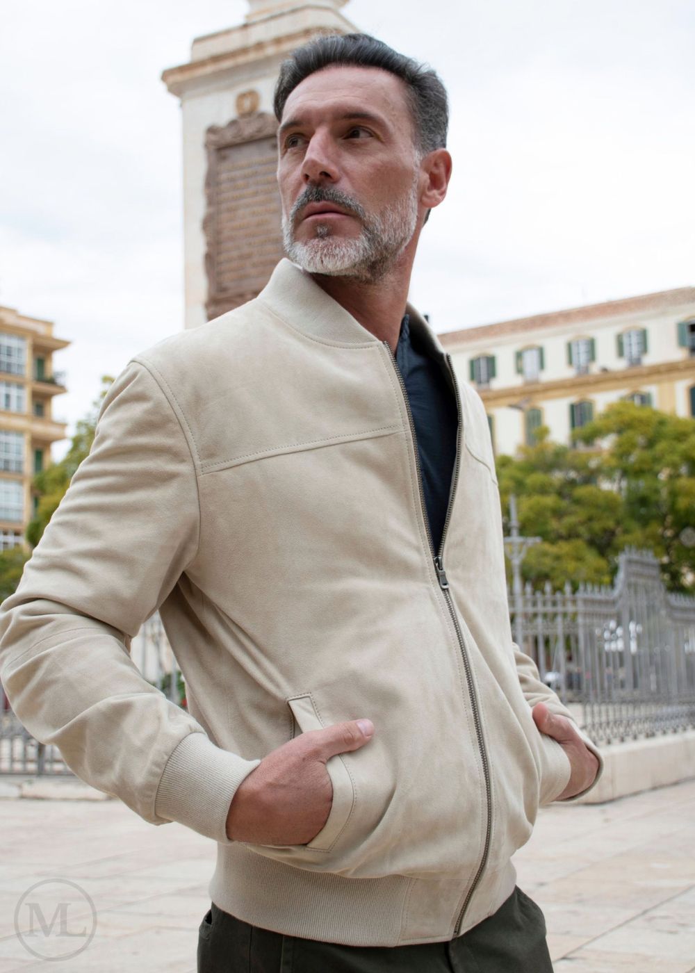 Man wearing a Ivory jacket outdoors with buildings in the background