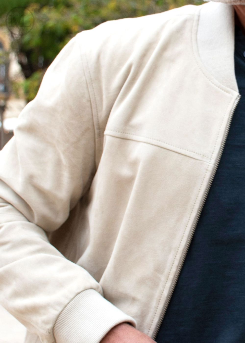 Close-up of a Men wearing a Ivory jacket with a blurred background