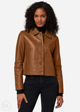 Woman wearing a brown leather cropped jacket on a white background