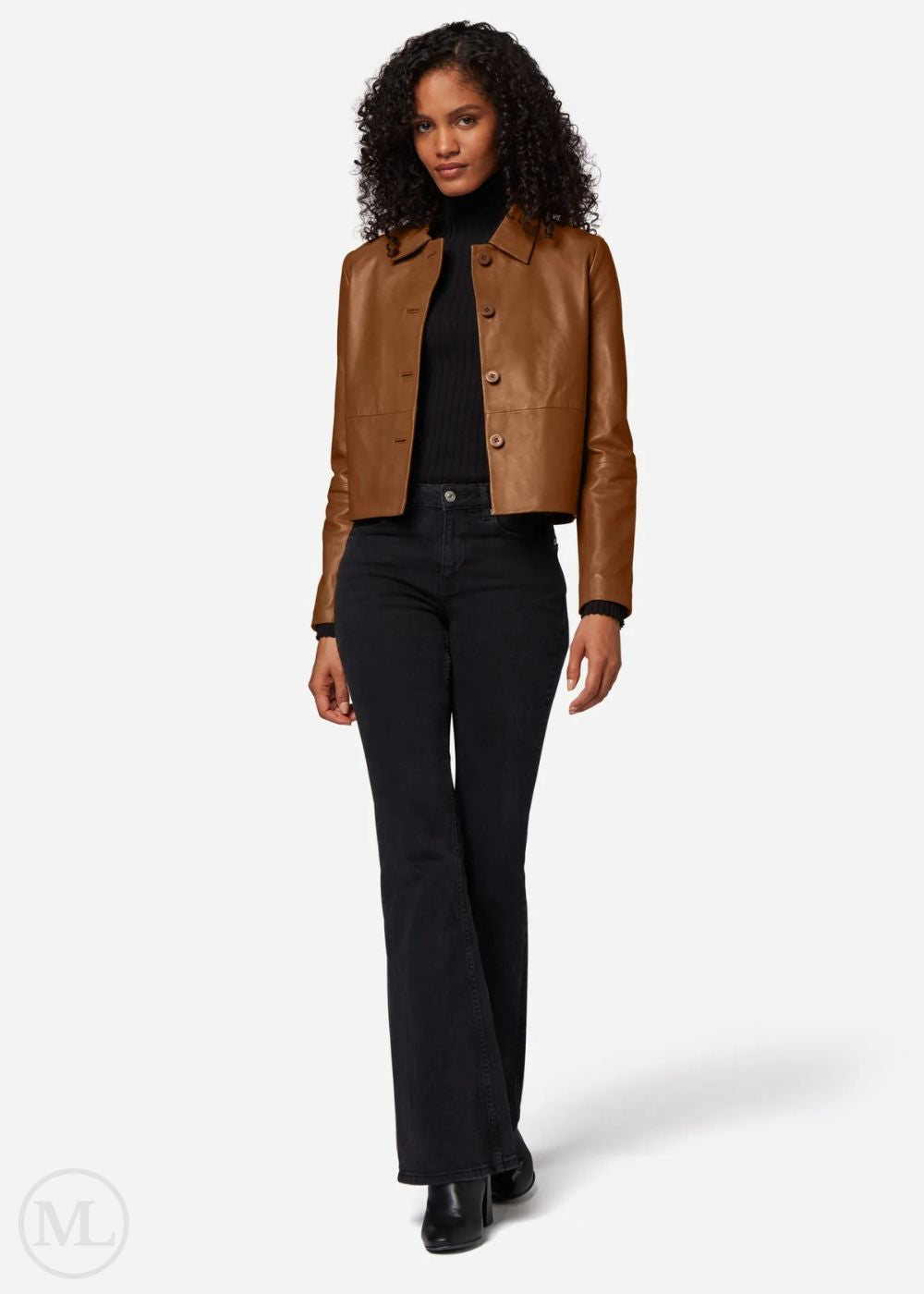 Woman wearing a brown leather cropped jacket and black pants on a white background