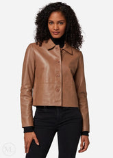 Woman wearing a camel leather cropped jacket on a white background