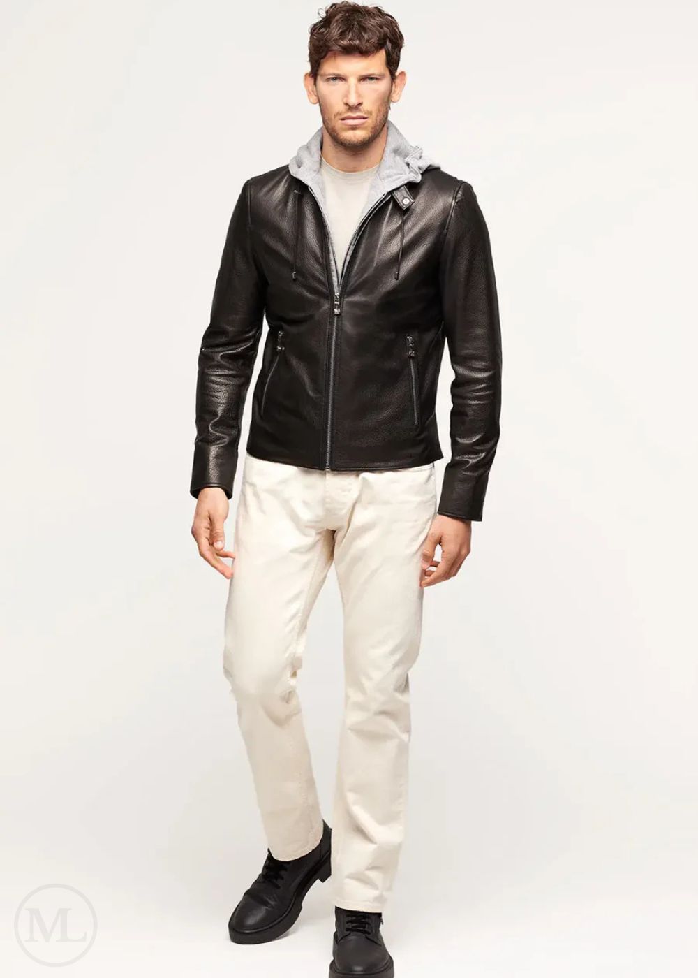 Man wearing a black lambskin leather jacket and white pants on a white background