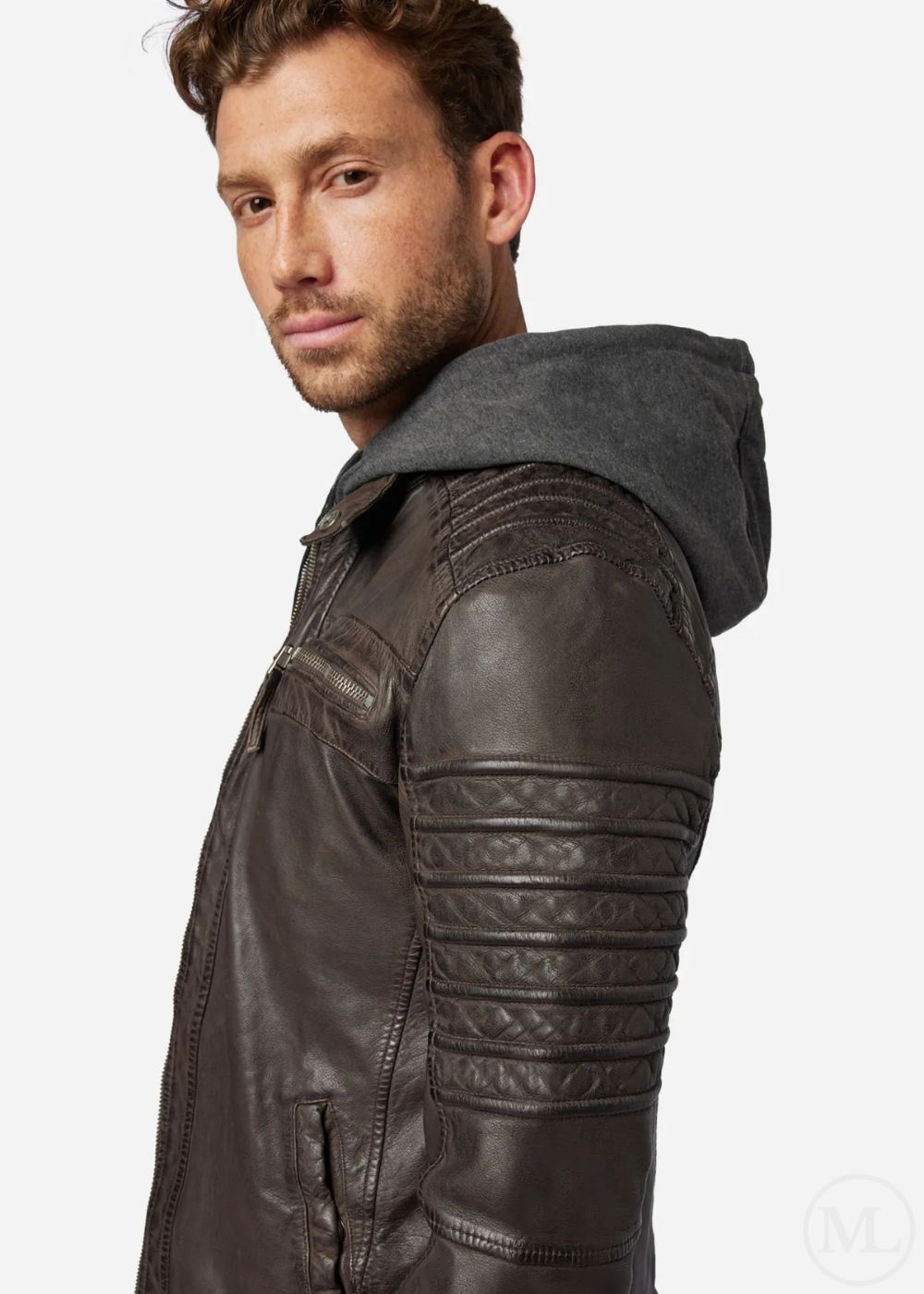 Man wearing a dark brown leather jacket with quilted details on a white background