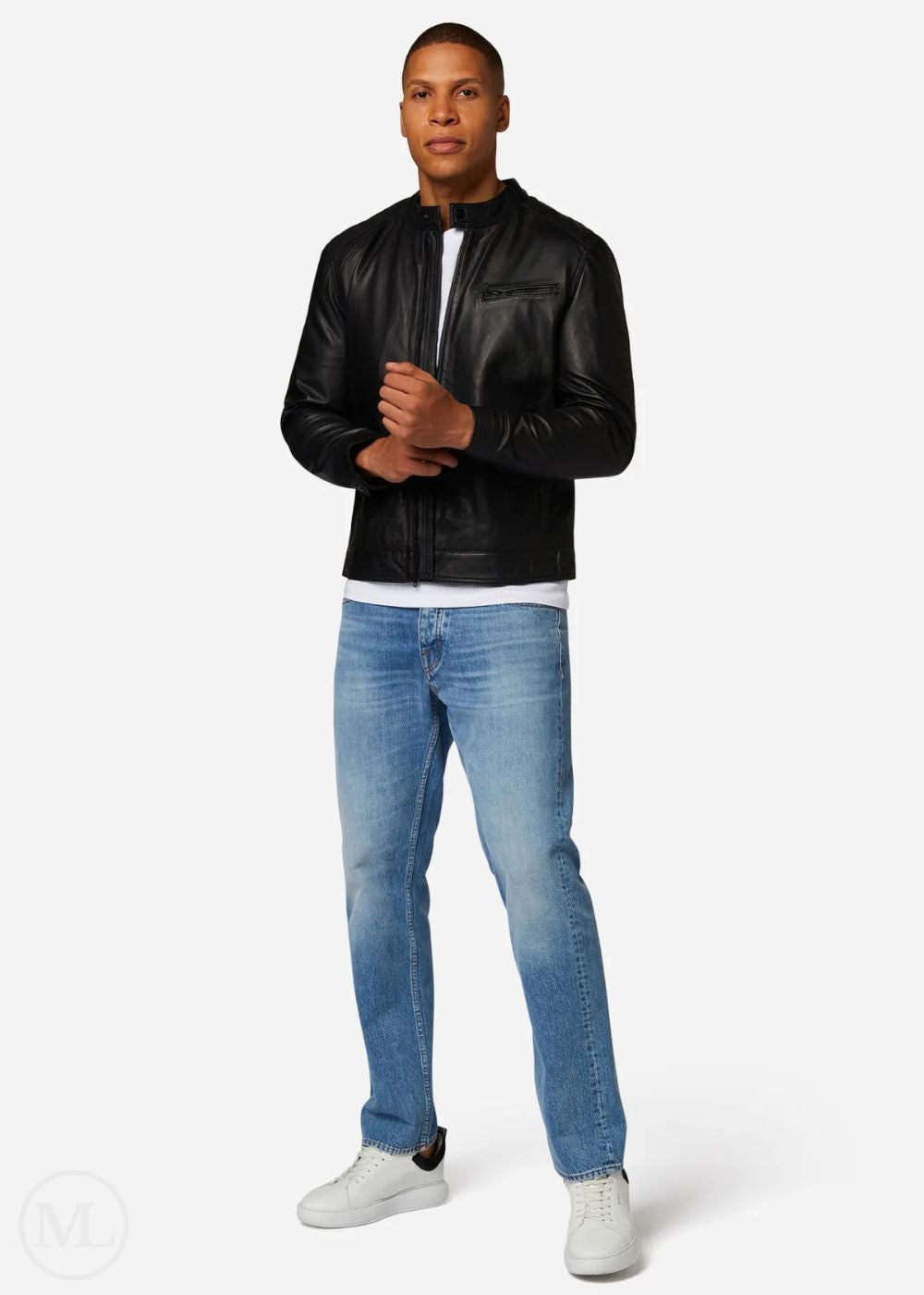 Man wearing a black leather jacket, white shirt, blue jeans, and white sneakers on a white background