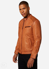 Man wearing a cognac brown leather jacket on a white background