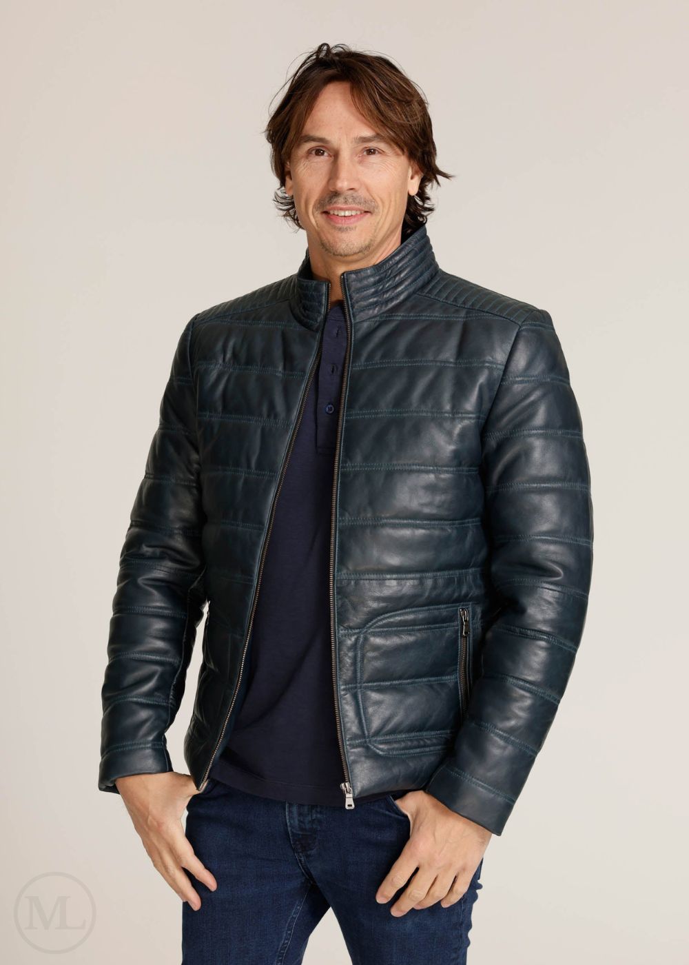 Man wearing a navy leather jacket on a plain background