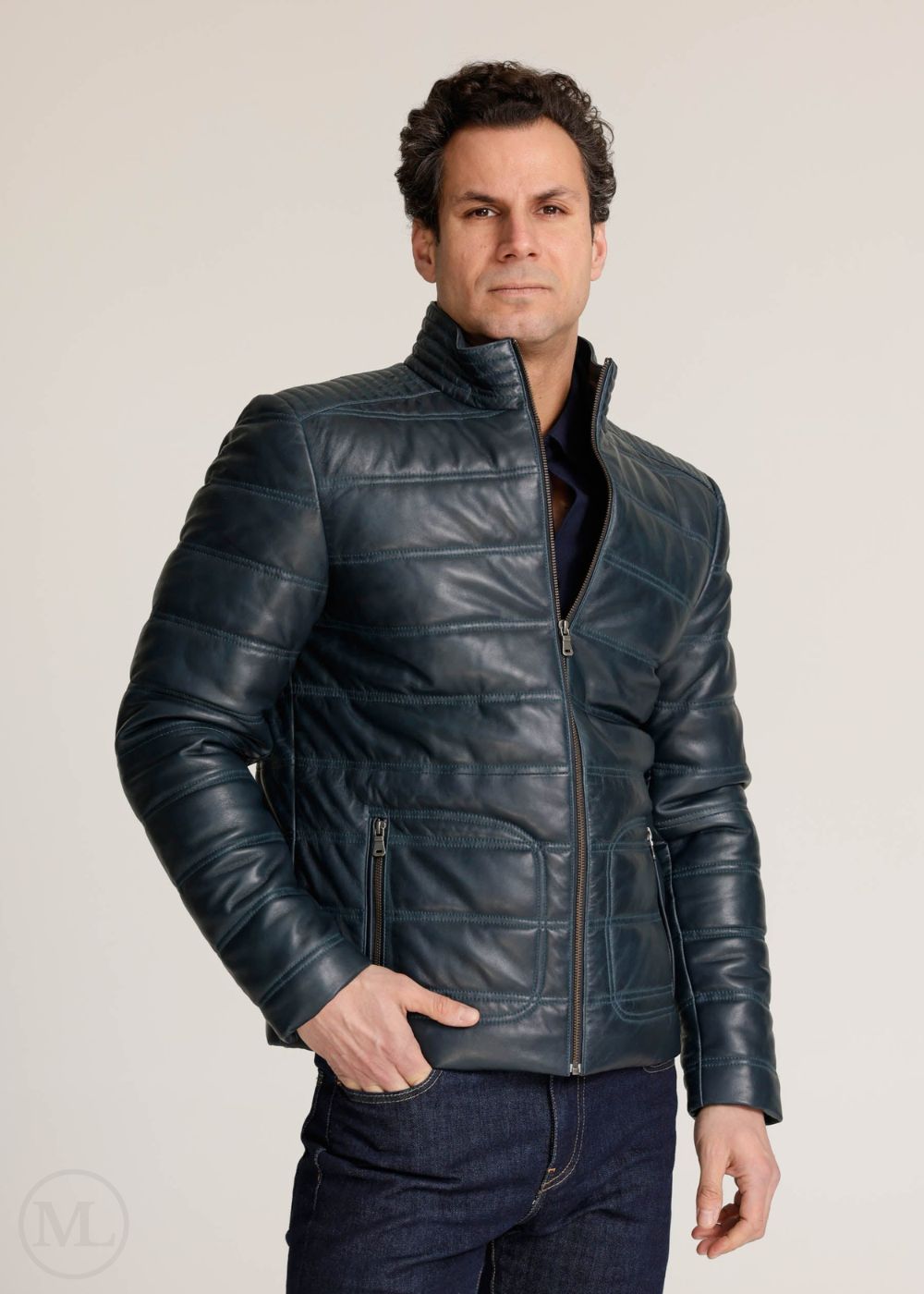 Man wearing a navy leather jacket against a plain background