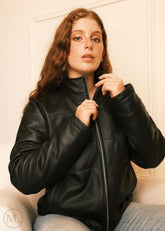 Women wearing a black leather Puffer down jacket , hands on zipper shot