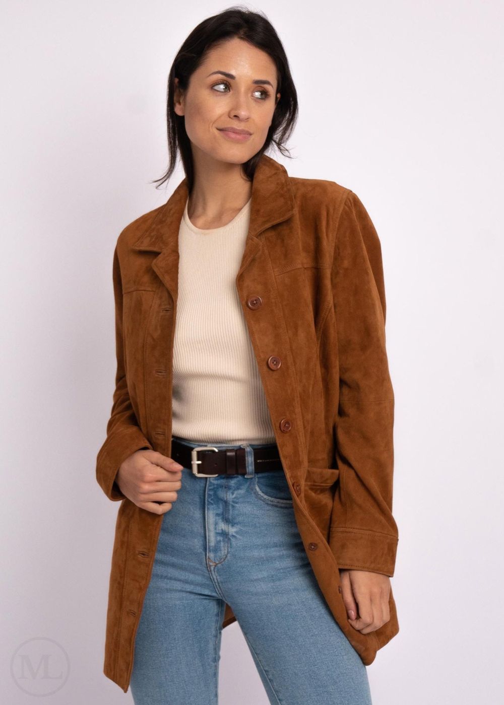 Woman wearing a cognac brown leather coat, white shirt, and blue jeans on a white background